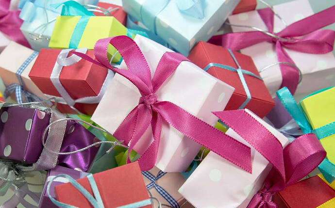 Heap of nicely wrapped packages in all shapes and sizes with a ribbon around them